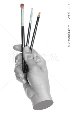 Woman hand holds black cosmetics brushes, isolated on transparent background, cosmetics and visage concept. Contemporary art Woman hand holds black cosmetics brushes, isolated on transparent background, cosmetics and visage concept. Contemporary art 129919297