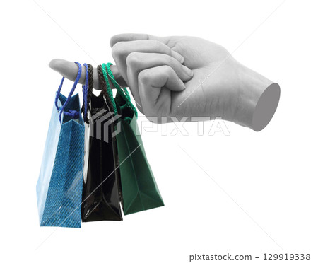Hand holds mini shopping bag, isolated on transparent background, shopping concept. Contemporary art design 129919338