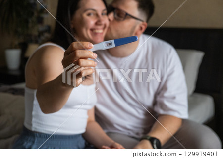 Happy Couple Celebrating Positive Pregnancy Test Happy Couple Celebrating Positive Pregnancy Test 129919401
