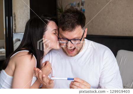 Happy Couple Celebrating Positive Pregnancy Test Happy Couple Celebrating Positive Pregnancy Test 129919403