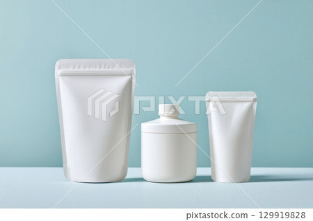 white cosmetic pouch on blue 129919828