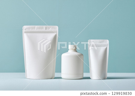 white cosmetic pouch container on blue 129919830