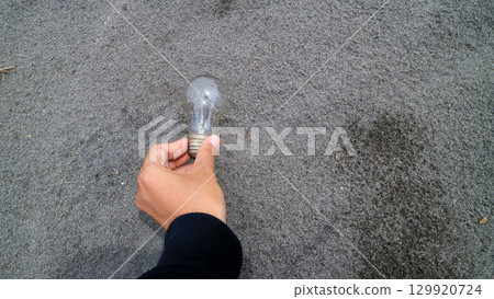 Hand holding light moon on sand background. Concept inspiration innovation. 129920724