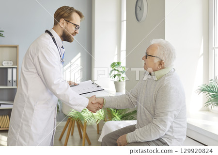 Doctor Shaking Hands With Senior Patient 129920824