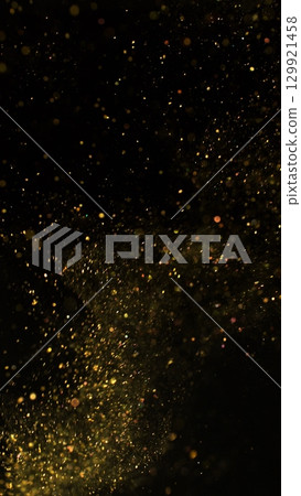 Freeze Motion Shot of Golden Glitter Background Isolated on Black 129921458