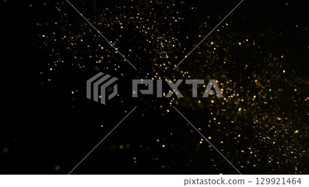 Freeze Motion Shot of Golden Glitter Background Isolated on Black 129921464