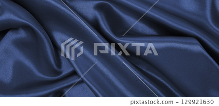 Smooth elegant dark grey silk or satin luxury cloth texture as abstract background. Luxurious background design Smooth elegant dark grey silk or satin luxury cloth texture as abstract background. Luxurious background design 129921630