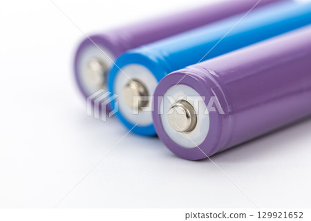 Colorful batteries closeup view cylindrical shape metallic terminal purple and blue energy storage clean background technology power supply macro detail Colorful batteries closeup view cylindrical shape metallic terminal purple and blue energy storage clean background technology power supply macro detail 129921652