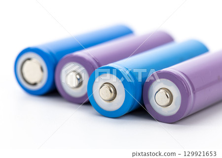 Colorful rechargeable batteries with blue and purple casing arranged in row on white background, showing metallic terminals and clean design, representing energy and technology 129921653