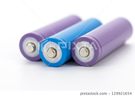 Purple and blue cylindrical rechargeable batteries arranged on white background close up clean modern energy storage technology power supply minimalistic vibrant color 129921654
