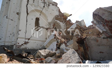 View to destroyed church at Kharkivska oblast. Ruined building after bomb attacks on ukrainian territory from russia army. Consequences of russian invasion of Ukraine. Slow motion 129923380