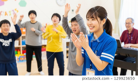 Smiling faces of a disabled person and a female support worker enjoying recreation at the facility 129923650