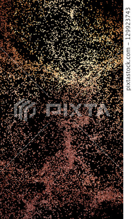 Swarm of small golden-orange particles floating on a black background, evoking dust, stars, or data points Swarm of small golden-orange particles floating on a black background, evoking dust, stars, or data points 129923743