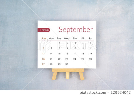 September 2026 calendar page with wooden easel, Flat lay. 129924042