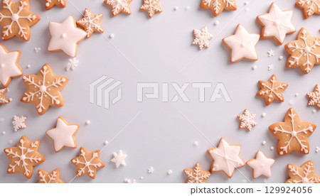 Winter frame background with snowflakes and star-shaped icing cookies 129924056