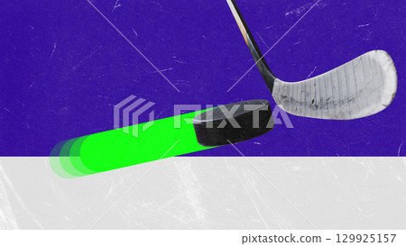 Creative collage. Hockey puck with neon glowing trail near stick on ice surface Creative collage. Hockey puck with neon glowing trail near stick on ice surface 129925157