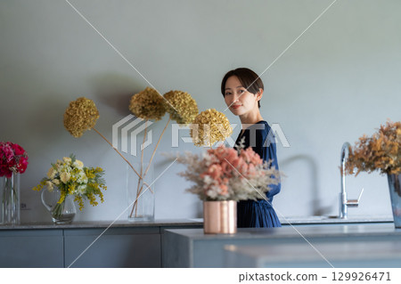 A woman living surrounded by flowers A woman living surrounded by flowers 129926471