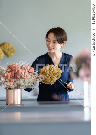 A woman living surrounded by flowers A woman living surrounded by flowers 129926490
