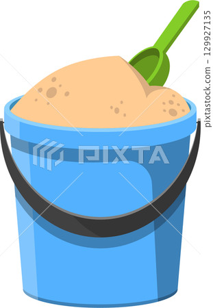 A blue bucket is filled with sand and a green shovel, inviting imaginative play and fun. 129927135