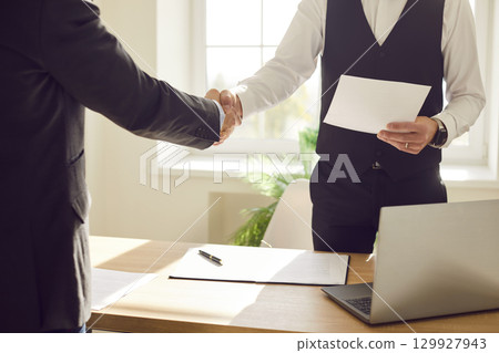Business people handshake in good greeting, showing agreement, contract, deal after negotiation 129927943
