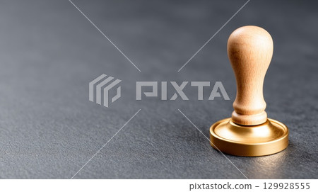 Wooden wax stamp tool on dark background 129928555