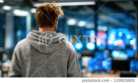 Man in Hoodie, Office with Screens 129928800