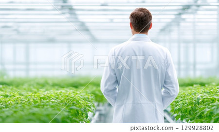 Man in White Lab Coat in Greenhouse Man in White Lab Coat in Greenhouse 129928802