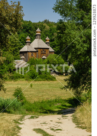 Old wooden church on a background of blue sky 129928873
