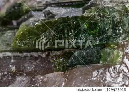 Macro mineral tourmaline stone in quartz on a white background Macro mineral tourmaline stone in quartz on a white background 129928918