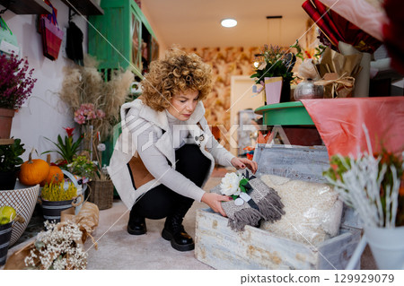 Curating natural beauty in a cozy flower shop during the serene morning hours 129929079