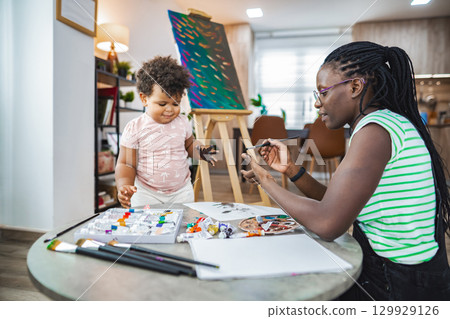 Creative bonding: A mother and child enjoy painting together 129929126