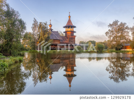 Wooden Orthodox church with reflection in pond, Blagoveshchenye village, Russia 129929178