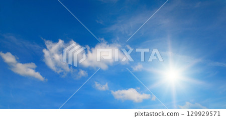 Bright Sun in a Blue Sky. Natural Weather Background. 129929571