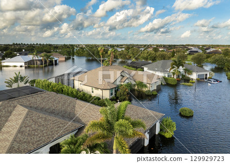 Flooding in Florida caused by tropical storm from hurricane rainfall. Suburb houses in residential community surrounded by flood waters. Aftermath of natural disaster 129929723