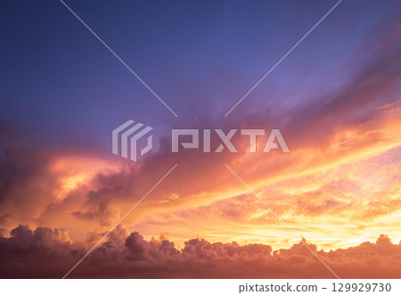 Sunset sky with bright colorful orange and yellow clouds. Panoramic skyscape Sunset sky with bright colorful orange and yellow clouds. Panoramic skyscape 129929730