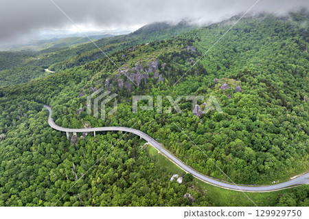 Winding mountain road in summer woods. Linn Cove Viaduct in Appalachian mountains in North Carolina with fresh green forest trees in summertime season. Beauty of USA nature 129929750