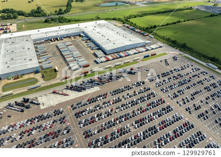 Aerial view of car factory parking lot with many brand new cars for sale. Development of American automotive industry concept 129929761