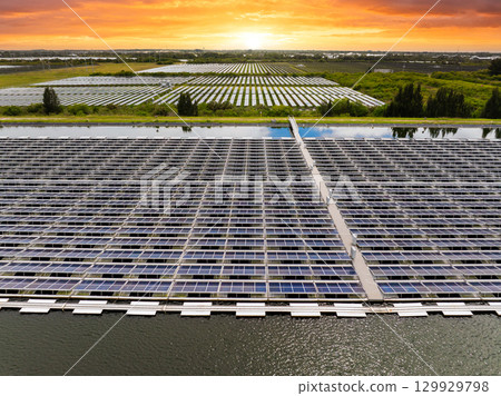 Floating solar panels at renewable electrical power plant for producing clean electric energy. Concept of sustainable photovoltaic electricity on water surface with zero emission Floating solar panels at renewable electrical power plant for producing clean electric energy. Concept of sustainable photovoltaic electricity on water surface with zero emission 129929798