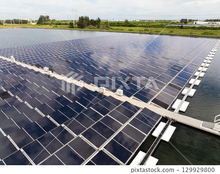 Production of sustainable photovoltaic electricity on water surface with zero emission. Floating solar panels at renewable electrical power plant for producing clean electric energy 129929800