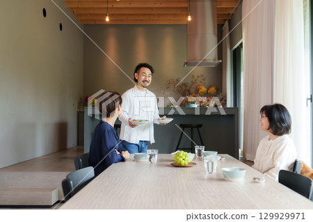 Family dining in a modern living/dining room Family dining in a modern living/dining room 129929971