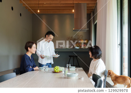 Family dining in a modern living/dining room Family dining in a modern living/dining room 129929978
