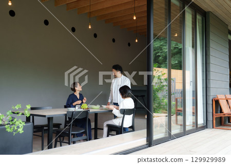 Family dining in a modern living/dining room Family dining in a modern living/dining room 129929989