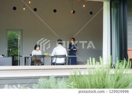 Family dining in a modern living/dining room 129929996