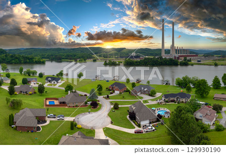 Thermal power plant polluting air burning coal fossil fuel for production of electrical energy. Private residential houses at Kingston power station in Roane County, Tennessee 129930190
