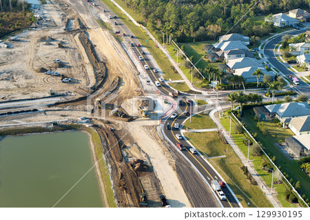 Aerial view of busy American highway road under construction. Development of roundabout traffic infrastructure. State transportation concept Aerial view of busy American highway road under construction. Development of roundabout traffic infrastructure. State transportation concept 129930195