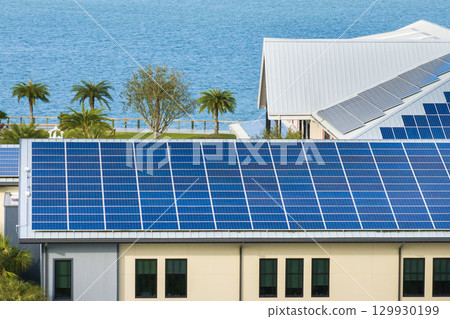 Photovoltaic panels on solar rooftop of Florida commercial building for producing clean ecological electrical energy. Renewable electricity with zero emission concept 129930199