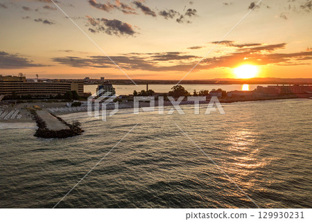 Aerial view of Pomorie city that is located on Black Sea shore. Top view of sand beaches with many hotel buildings and tourist infrastructure. 129930231