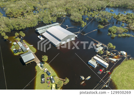 Flooded industrial business warehouse by hurricane Ian rainfall in Florida rural area. Consequences of natural disaster 129930269