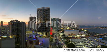 View from above of brightly illuminated skyscraper buildings in downtown district of Miami Brickell in Florida, USA at night. American megapolis with business financial district View from above of brightly illuminated skyscraper buildings in downtown district of Miami Brickell in Florida, USA at night. American megapolis with business financial district 129930277