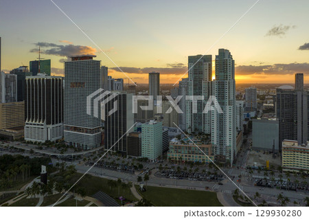 Evening urban landscape of downtown district of Miami Brickell in Florida USA. Skyline with dark high skyscraper buildings and street with cars and Metrorail traffic in modern american megapolis 129930280